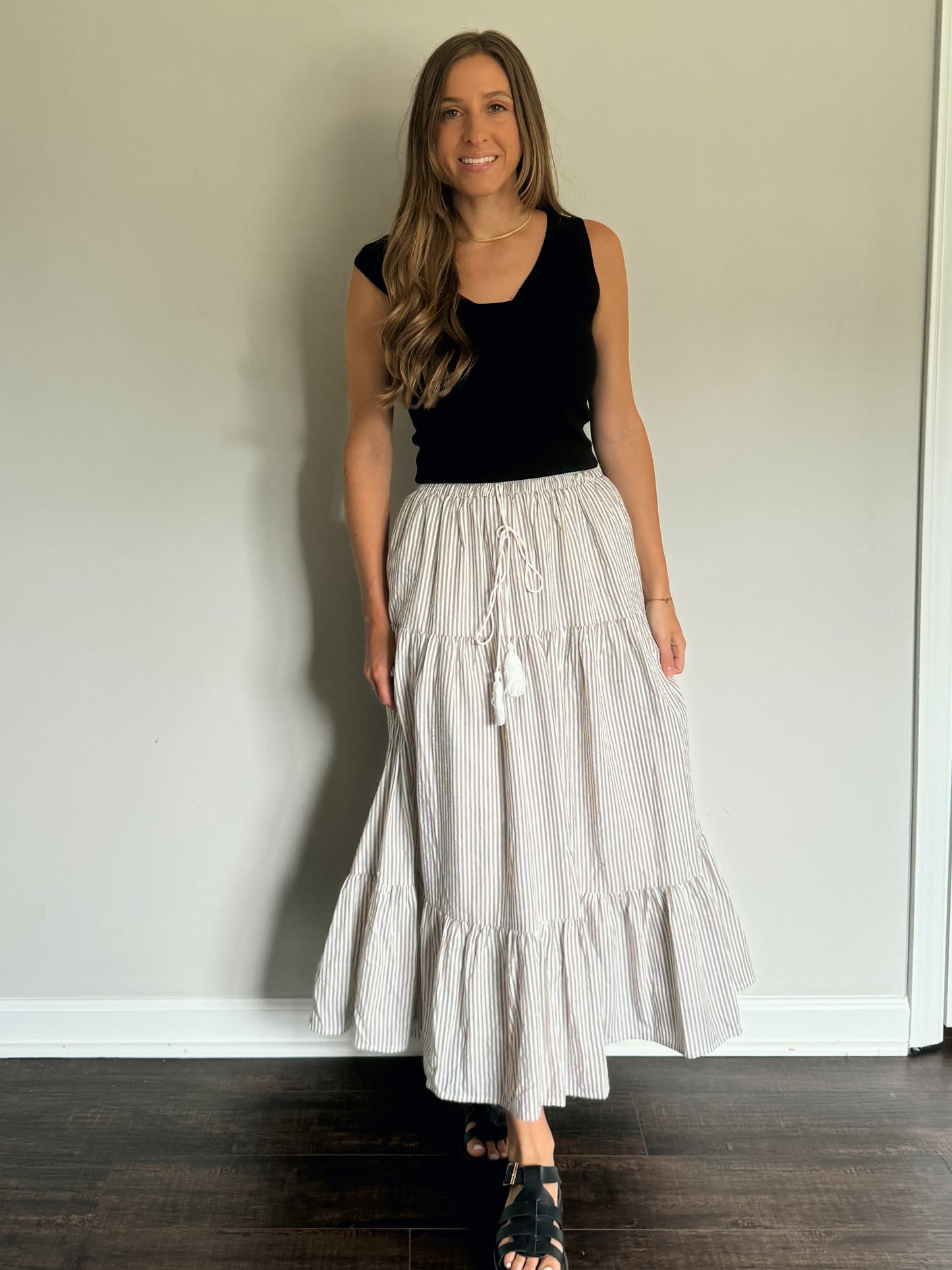 black off shoulder knit top with striped maxi skirt