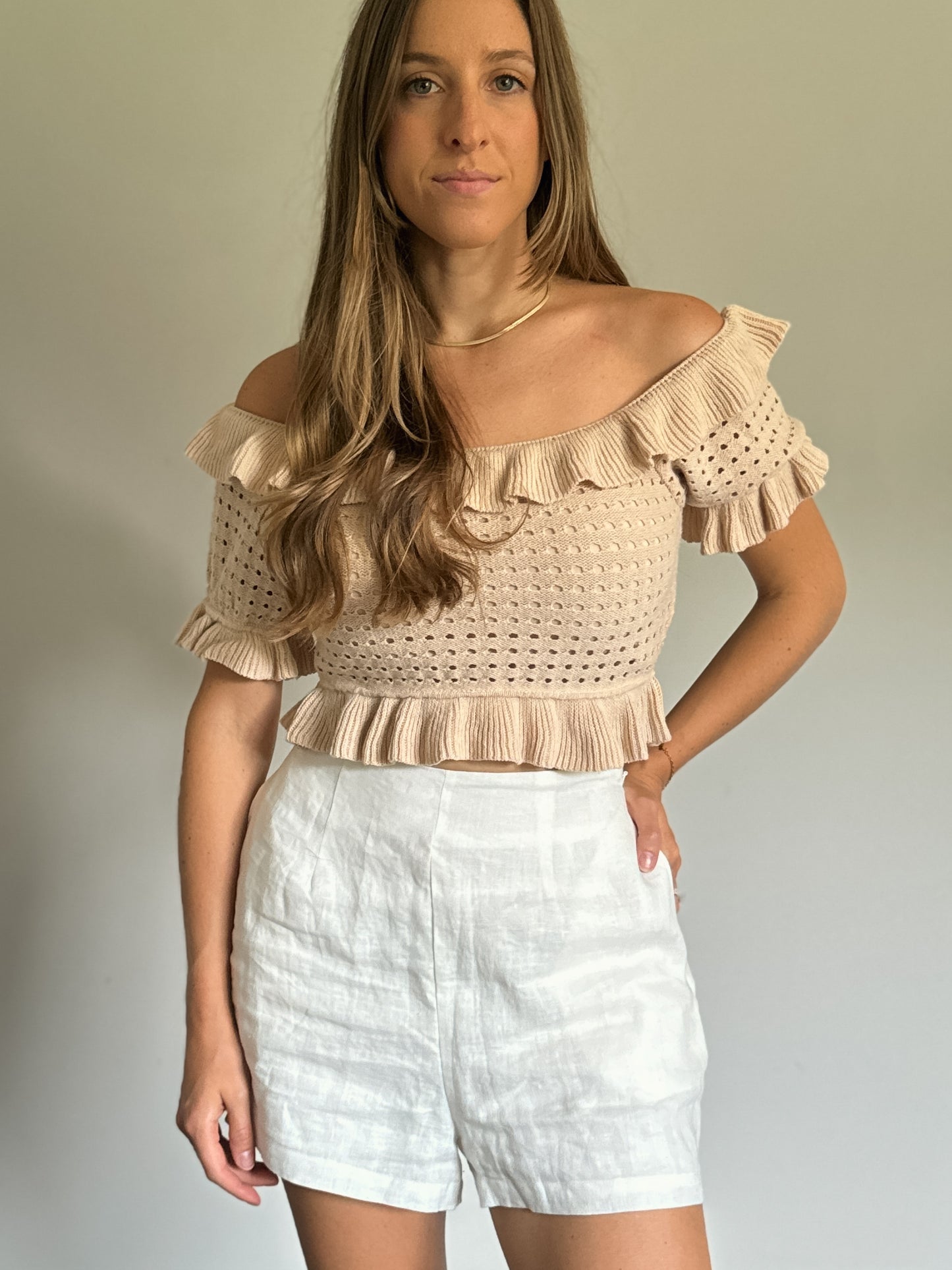 ruffled off shoulder knit top with white linen shorts