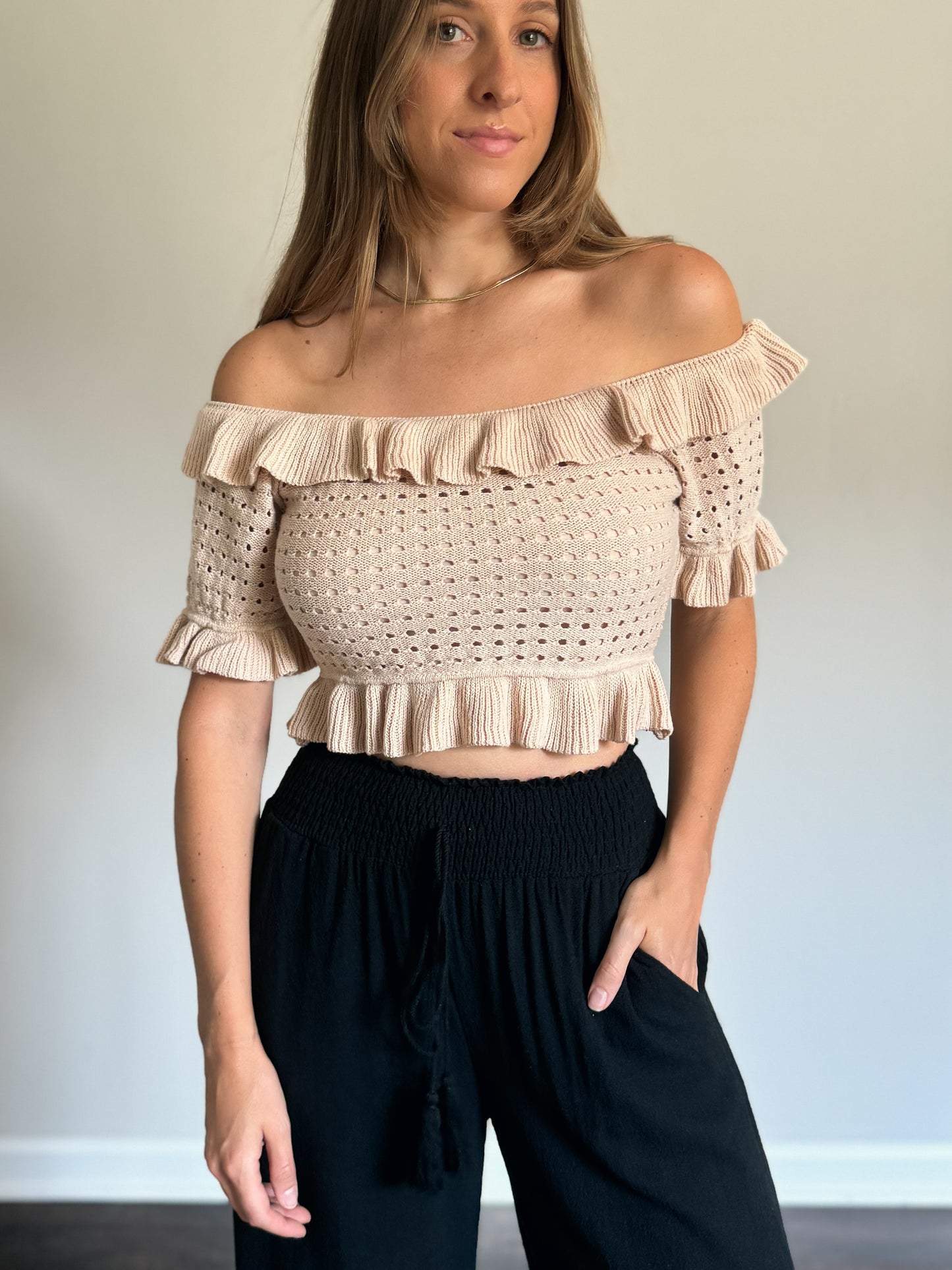 ruffled off shoulder knit top with black linen pants