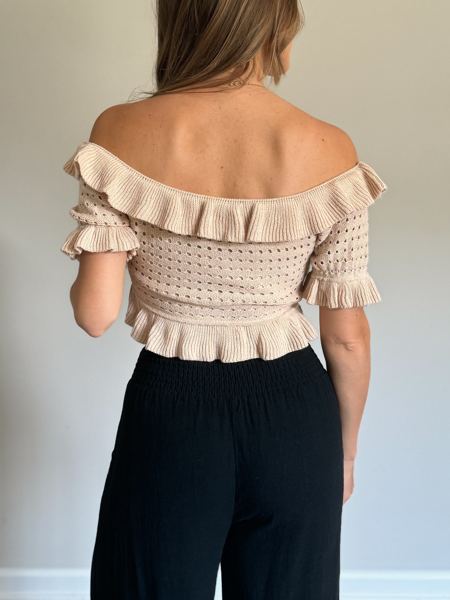 ruffled off shoulder knit top with black linen pants