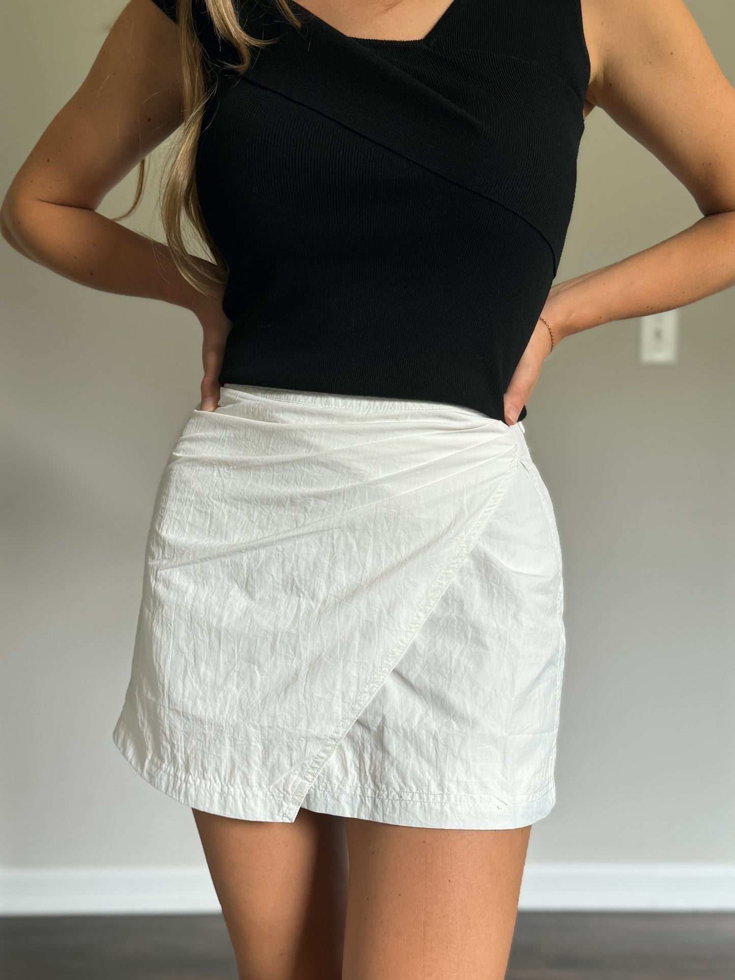 white mini skirt with black off shoulder knit top